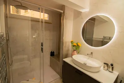 a bathroom with a sink and a shower with a mirror at Bruno Domus Design in Rome