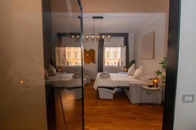 a room with two beds and a glass shower at Bruno Domus Design in Rome
