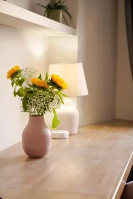a vase with flowers in it sitting on a table at Bruno Domus Design in Rome