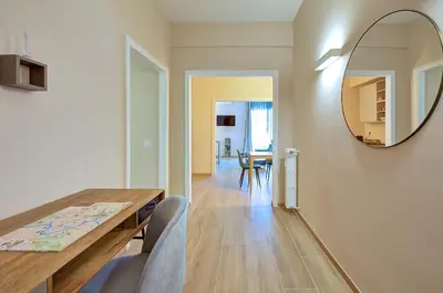 a dining room with a table and a mirror at Vatican Pop House in Rome
