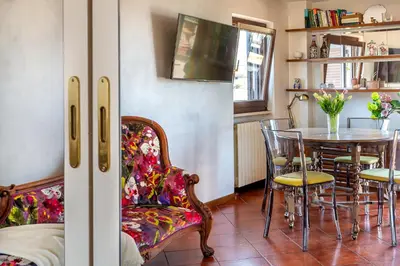 a dining room with a table and chairs at iFlat Campo de' Fiori Panoramic Penthouse in Rome