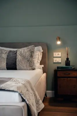 a bedroom with a bed and a dresser with a night stand at NAMAN HOTELLERIE - Monti in Rome