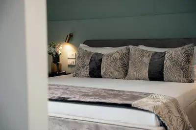 a bedroom with a bed with pillows at NAMAN HOTELLERIE - Monti in Rome