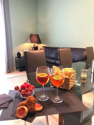 two glasses of wine and bread on a table at Testaccio Bodoni apartment in Rome