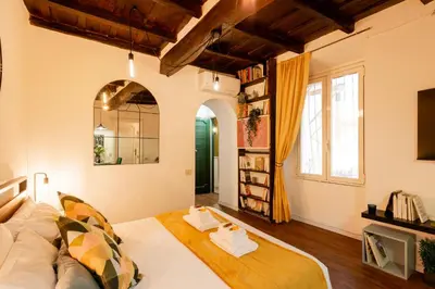 a living room with a bed and a window at Studio Campo de' Fiori in Rome