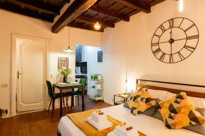 a bedroom with a large clock on the wall at Studio Campo de' Fiori in Rome