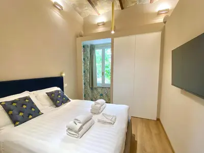 a bedroom with a bed with towels on it at Queen of Rome Luxury Rooms in Rome