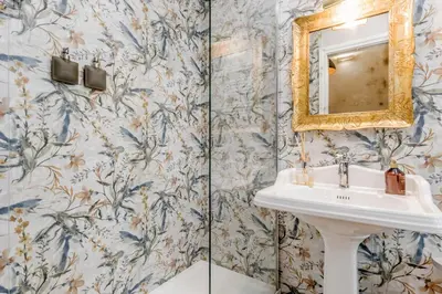 a bathroom with a sink and a mirror at Queen of Rome Luxury Rooms in Rome
