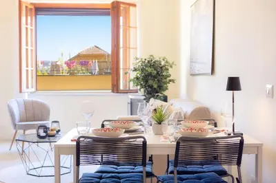 a dining room with a table and two chairs at Appartamento Vatican Terrace in Rome