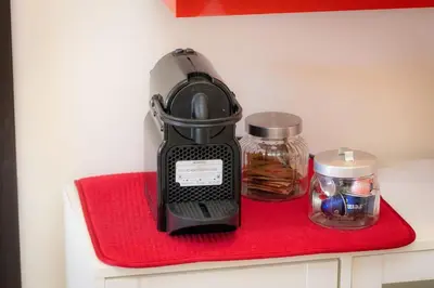 a black blender sitting on a red towel at Appartamento Vatican Terrace in Rome