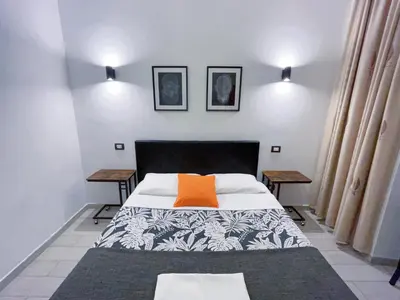 a bedroom with a bed with an orange pillow on it at Overseas Guesthouse in Rome