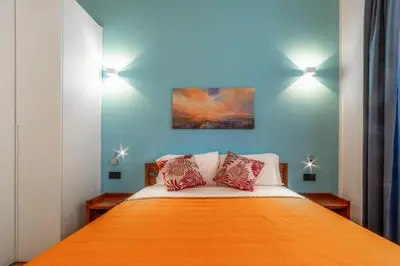a bedroom with a bed with two pillows on it at Luxury Vatican Rooms - next to the Vatican Museum in Rome