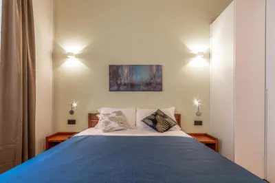 a bedroom with a bed with two pillows on it at Luxury Vatican Rooms - next to the Vatican Museum in Rome