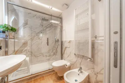 a bathroom with a shower and a toilet and a sink at Luxury Vatican Rooms - next to the Vatican Museum in Rome