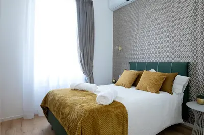 a bedroom with a large bed with yellow pillows at LV Vatican boutique apartment in Rome