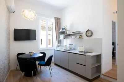a kitchen and dining room with a table and chairs at LV Vatican boutique apartment in Rome