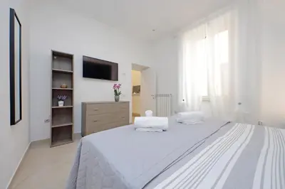 a bedroom with a bed and a wall mural at Alba Home Re Di Roma in Rome