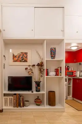 a living room with white cabinets and a tv at Navona Romantic House in Rome