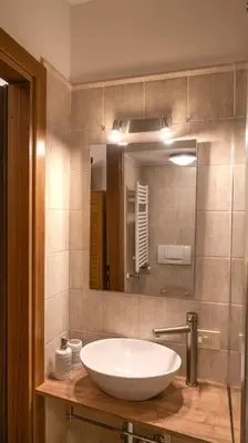 a bathroom with a white sink and a mirror at Navona Romantic House in Rome