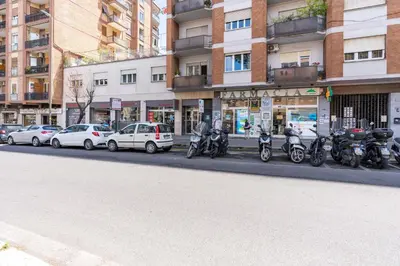 a row of motorcycles parked on the side of a city street at 5 Minutes to St Peter - Luxury Stay in Rome