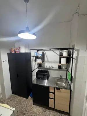 a small kitchen with a sink and a light at Baraka 24 in Rome