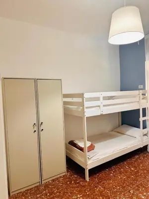a room with a bunk bed and a lamp at Baraka 24 in Rome
