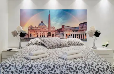 a bedroom with a king sized bed with a painting of a building at B&B Behind the Vatican in Rome