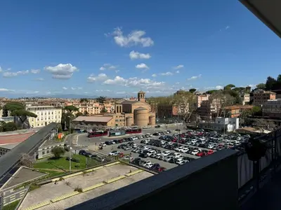 a parking lot full of cars in a city at B&B Behind the Vatican in Rome