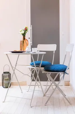 a dining room table with two chairs and a vase of flowers at Al Centro di Roma - Vaticano in Rome