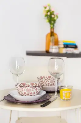 a table with two glasses and two bowls and plates at Al Centro di Roma - Vaticano in Rome
