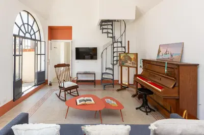a living room with a piano and a table at Amazing Penthouse Vaticano in Rome