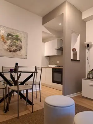 a kitchen and dining room with a table and chairs at La Casetta di Ponte Milvio con parcheggio in Rome