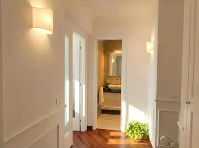 a hallway with a bathroom with a sink and a mirror at Saint John Loft in Rome