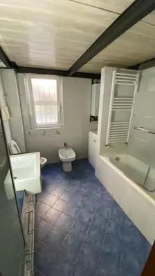 a bathroom with a toilet and a sink and a tub at Caffa Apartment in Rome