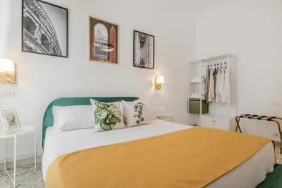 a bedroom with a bed with a yellow blanket on it at Apartment Maison 170 - Rome in Rome