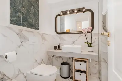 a bathroom with a sink and a mirror at Apartment Maison 170 - Rome in Rome