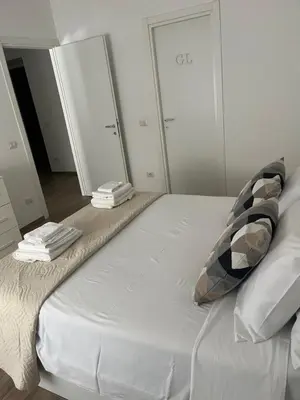 a white bed with two pillows on top of it at LoveRhome Apartment 10 in Rome