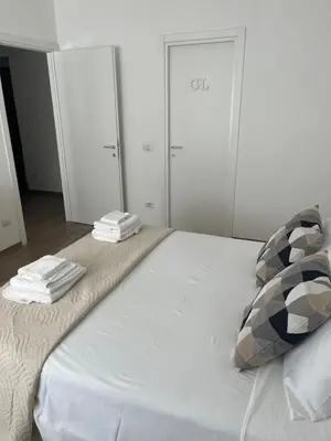 a large white bed with towels on top of it at LoveRhome Apartment 10 in Rome