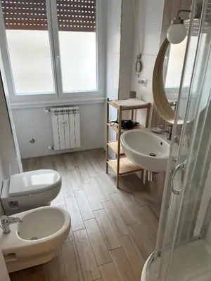 a bathroom with two sinks and a toilet and a shower at LoveRhome Apartment 10 in Rome