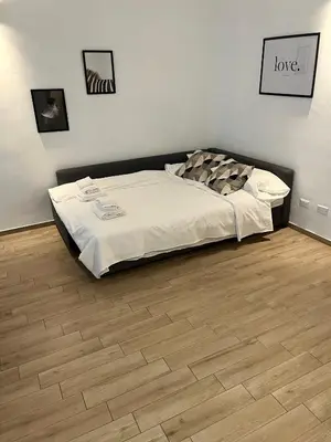 a bed in a room with a wooden floor at LoveRhome Apartment 10 in Rome