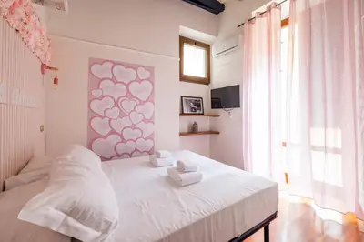 a bedroom with a white bed with two towels on it at maison Trevi in Rome