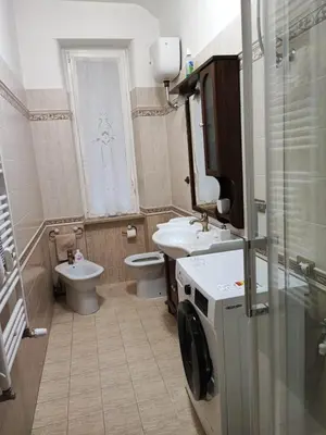 a bathroom with a sink and a toilet and a window at Iannilli Casa Vacanze in Rome