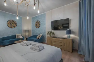 a bedroom with a bed and a tv and a couch at Piazza del Popolo - The Heart of Rome in Rome