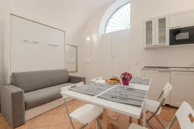 a living room with a table and a couch at Cozy Rhome in Rome