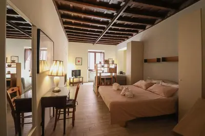 a bedroom with a bed and a table and a desk at Ciambella Cozy Flat in Rome