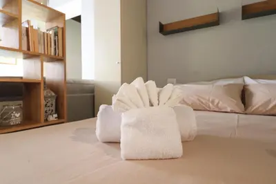 a pile of towels sitting on top of a bed at Ciambella Cozy Flat in Rome