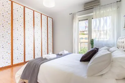 a white bed in a room with a window at Balduina Retreat Terrace in Rome