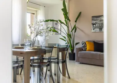 a dining room with a table and chairs and a couch at Balduina Retreat Terrace in Rome