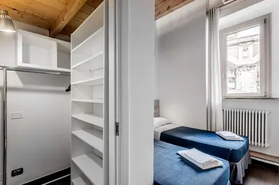 a small bedroom with a bed and a closet at Vatican Bridge Home in Rome