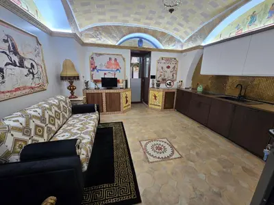 a living room with a couch and a kitchen at The Etrurian Rapsody in Rome